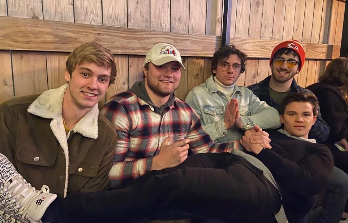 Five men look and smile at the camera